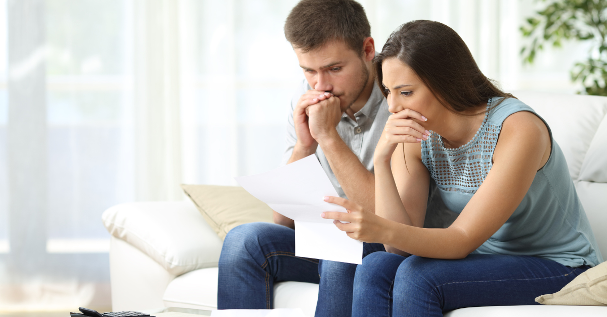 man and woman sitting on sofa